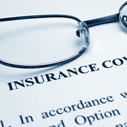 Glasses sitting on top of insurance form