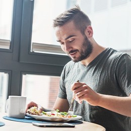 Man sitting at table enjoying a meal