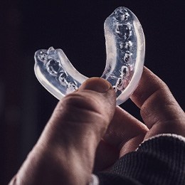 Close-up of hand holding a mouthguard