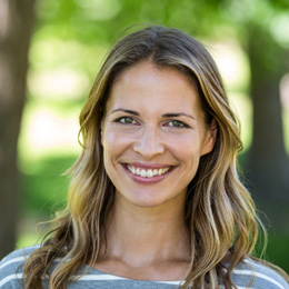 Woman standing in park and smiling