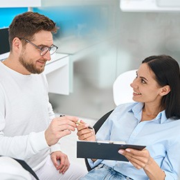Dentist and patient discussing cost of care