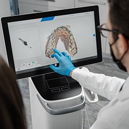 Dentist looking at impressions of patient's teeth