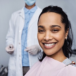 Woman smiling while sitting in dentist's treatment chair