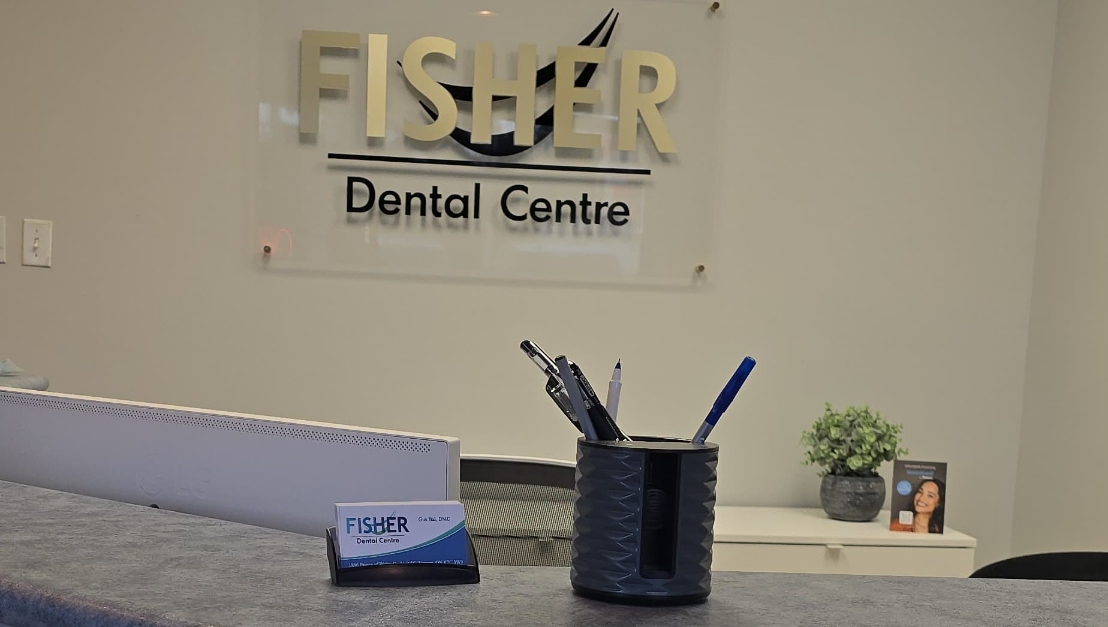Reception desk featuring Fisher Dental office sign