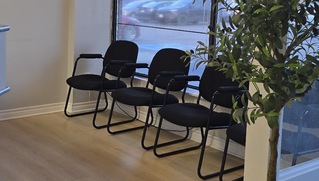 Patient waiting room with chairs at Fisher Dental