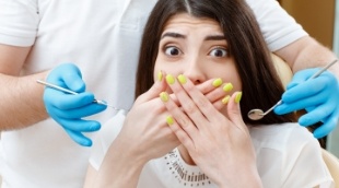 Surprised woman covering her mouth with her hands
