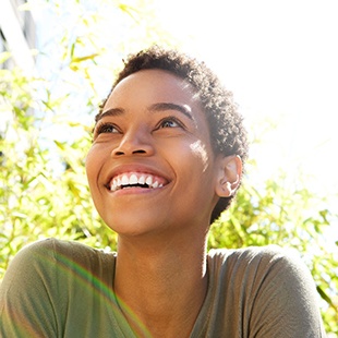 A smiling woman looking off camera 