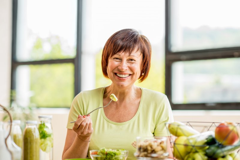 Older woman eating with her dentures