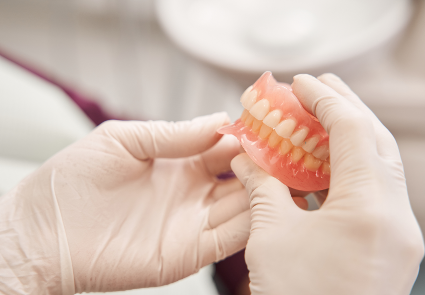 Dentist holding dentures